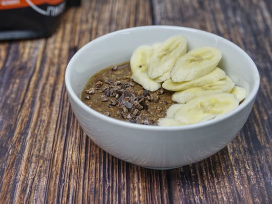 Photo of Growli Muesli with added cacao powder, sliced bananas, cacao nibs and spray cream